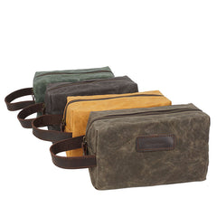 The Dulwich Wrist Pouch in oil-waxed canvas with a cowhide wrist strap
